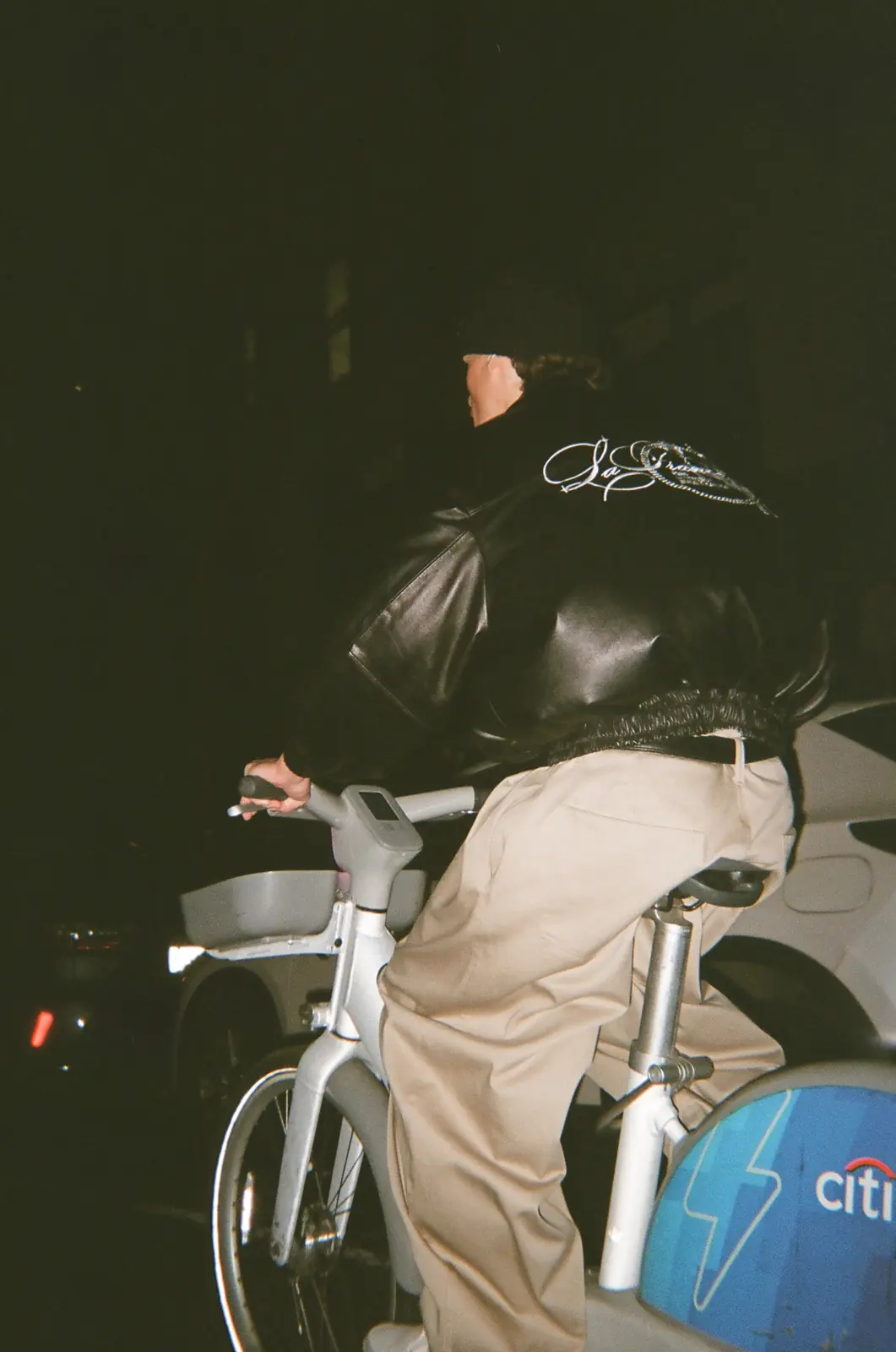 Two people seated together in dark jackets