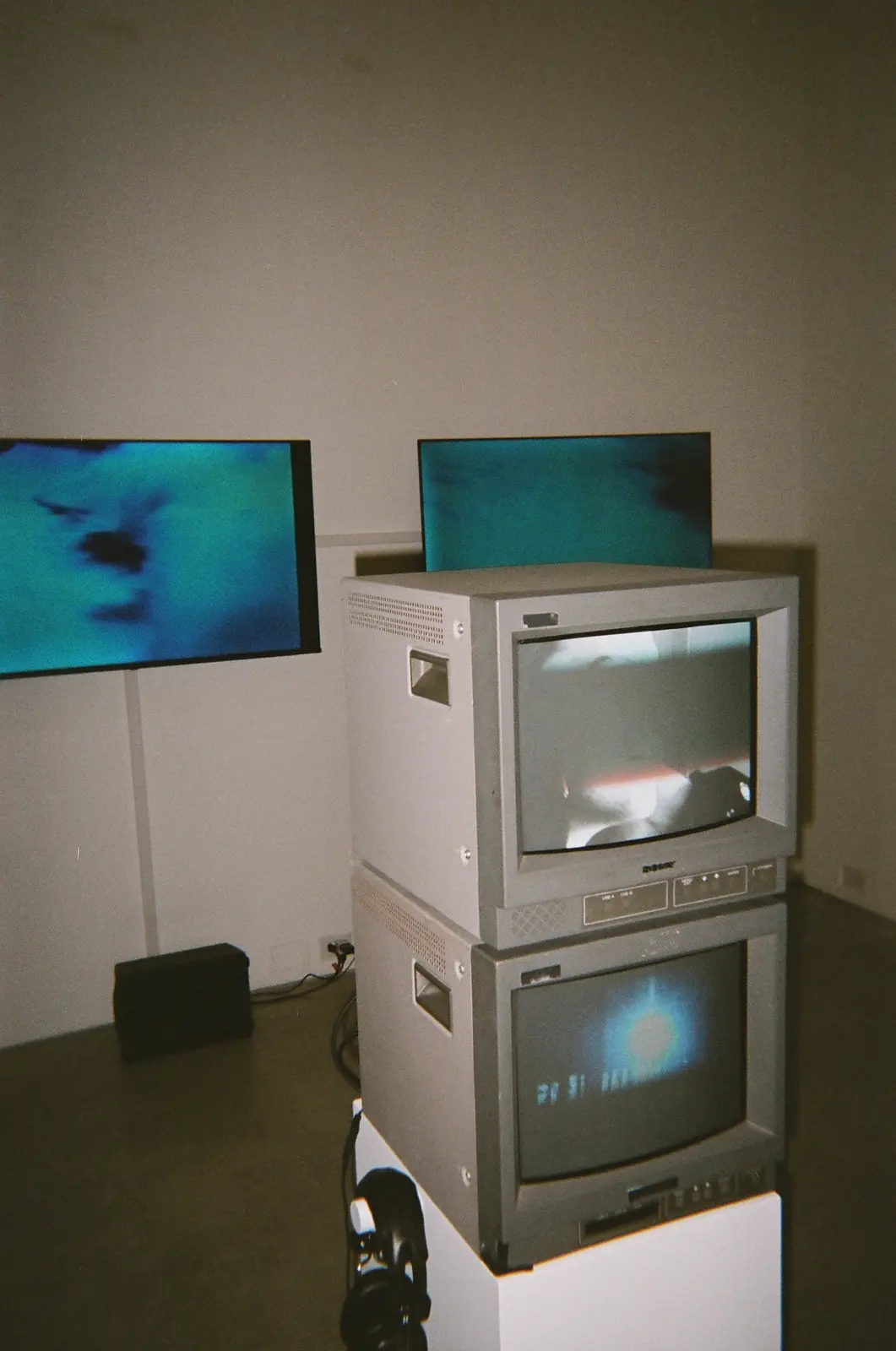 Stacked video monitors displaying blue imagery