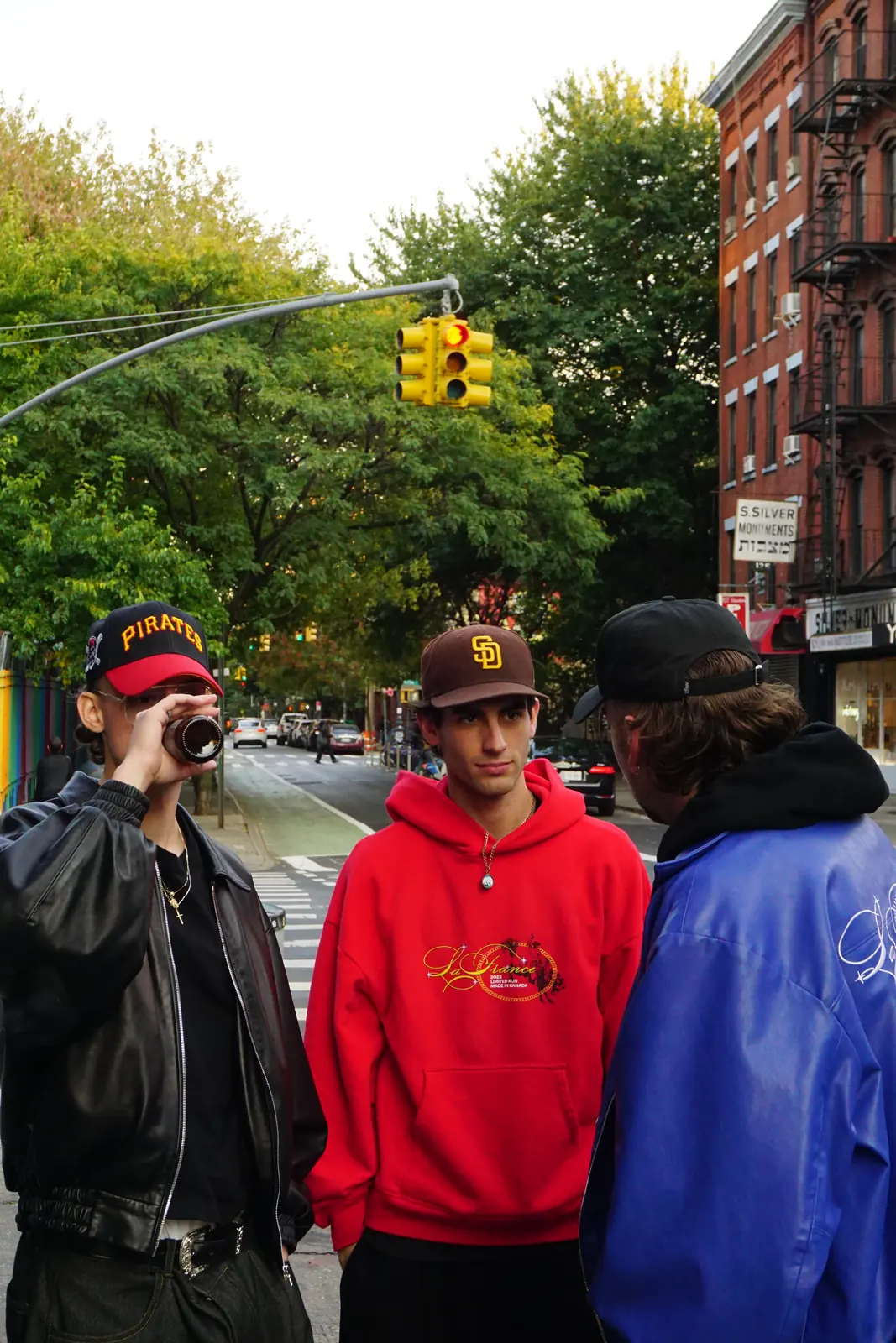 Three friends standing together on a street