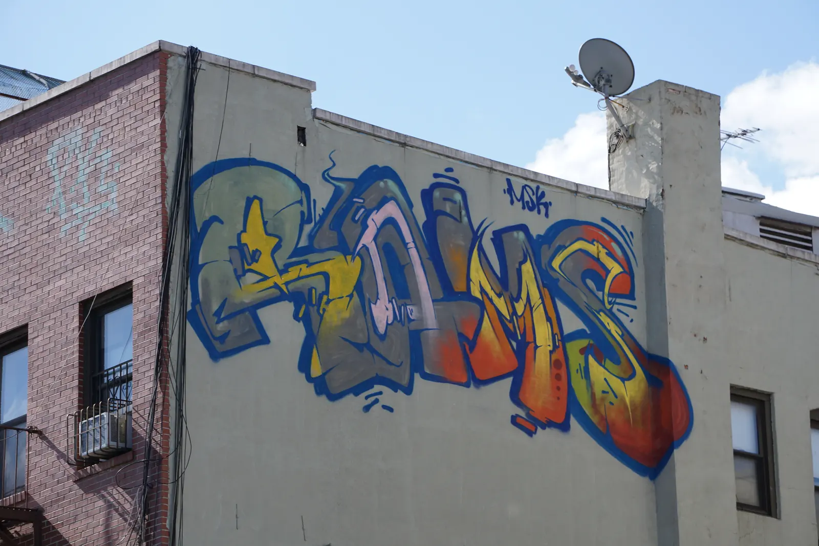 Colourful mural painted across a brick building