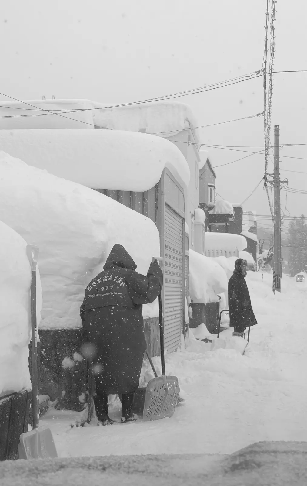 People walking beside deep snowbanks