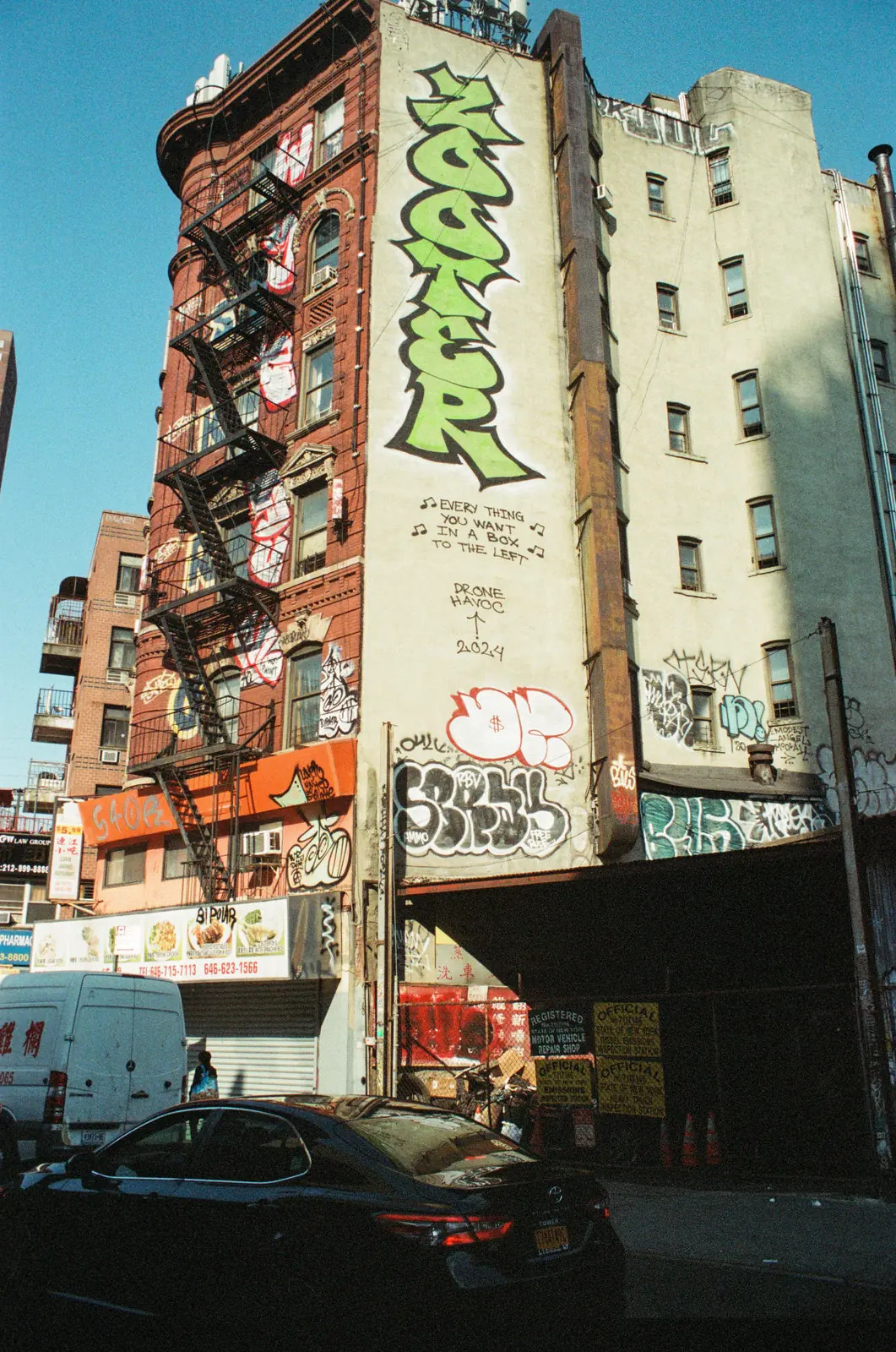 Layered signs and graffiti on city buildings