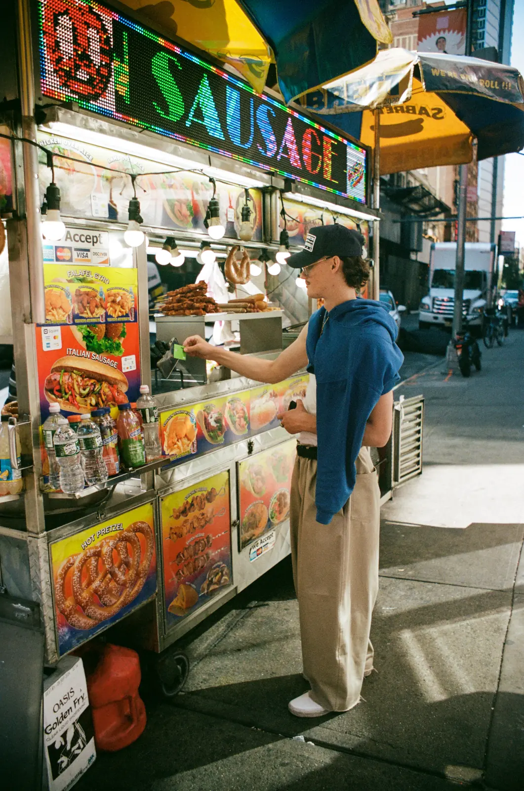 Vendor working at a colourful street food stand