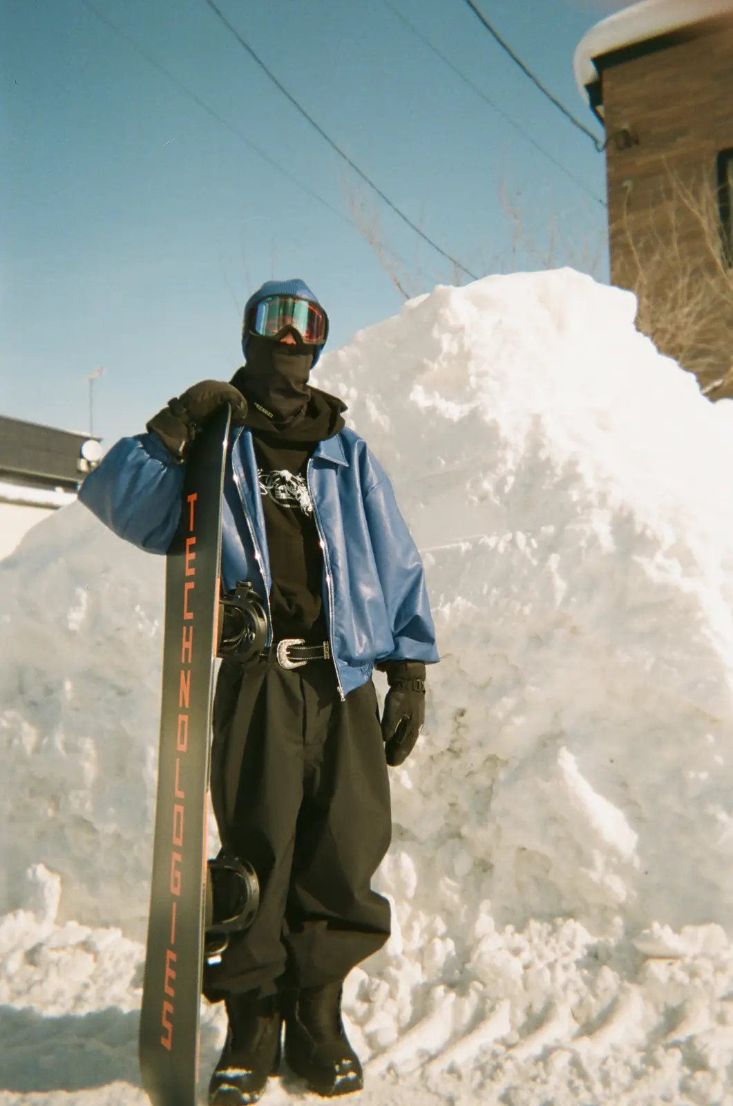 Skier standing beside a high snowbank