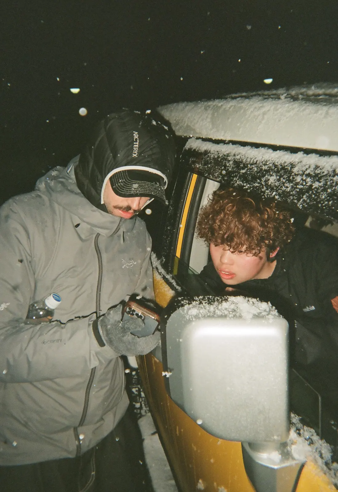 Two friends riding together in winter gear