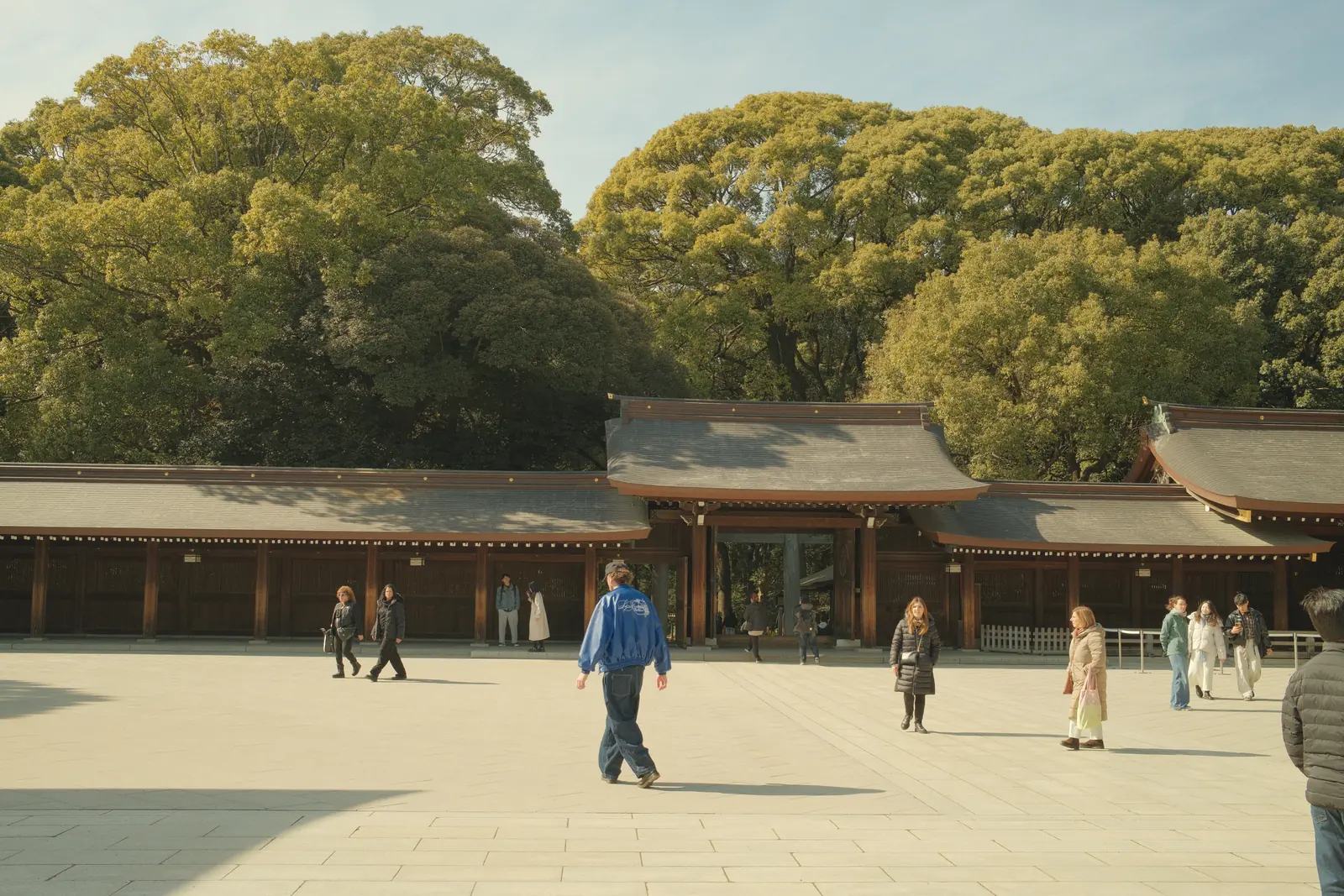 Visitors crossing a broad shrine courtyard