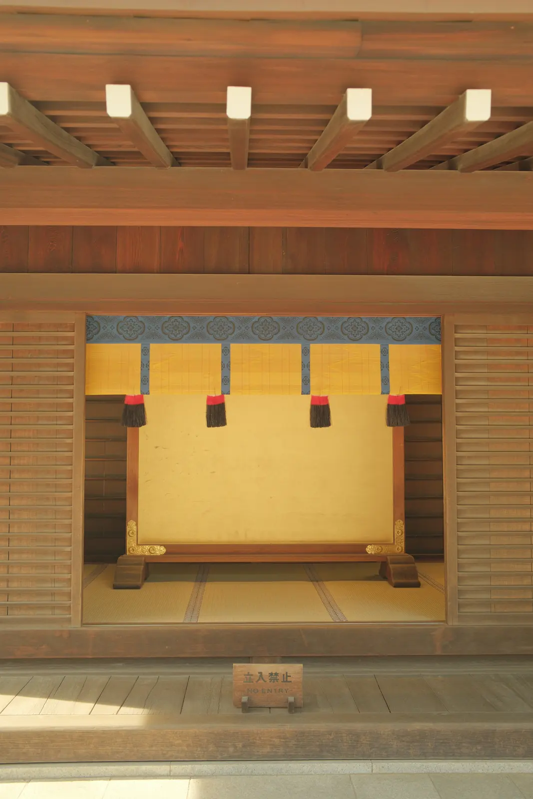 Colourful textile displayed against a wooden wall
