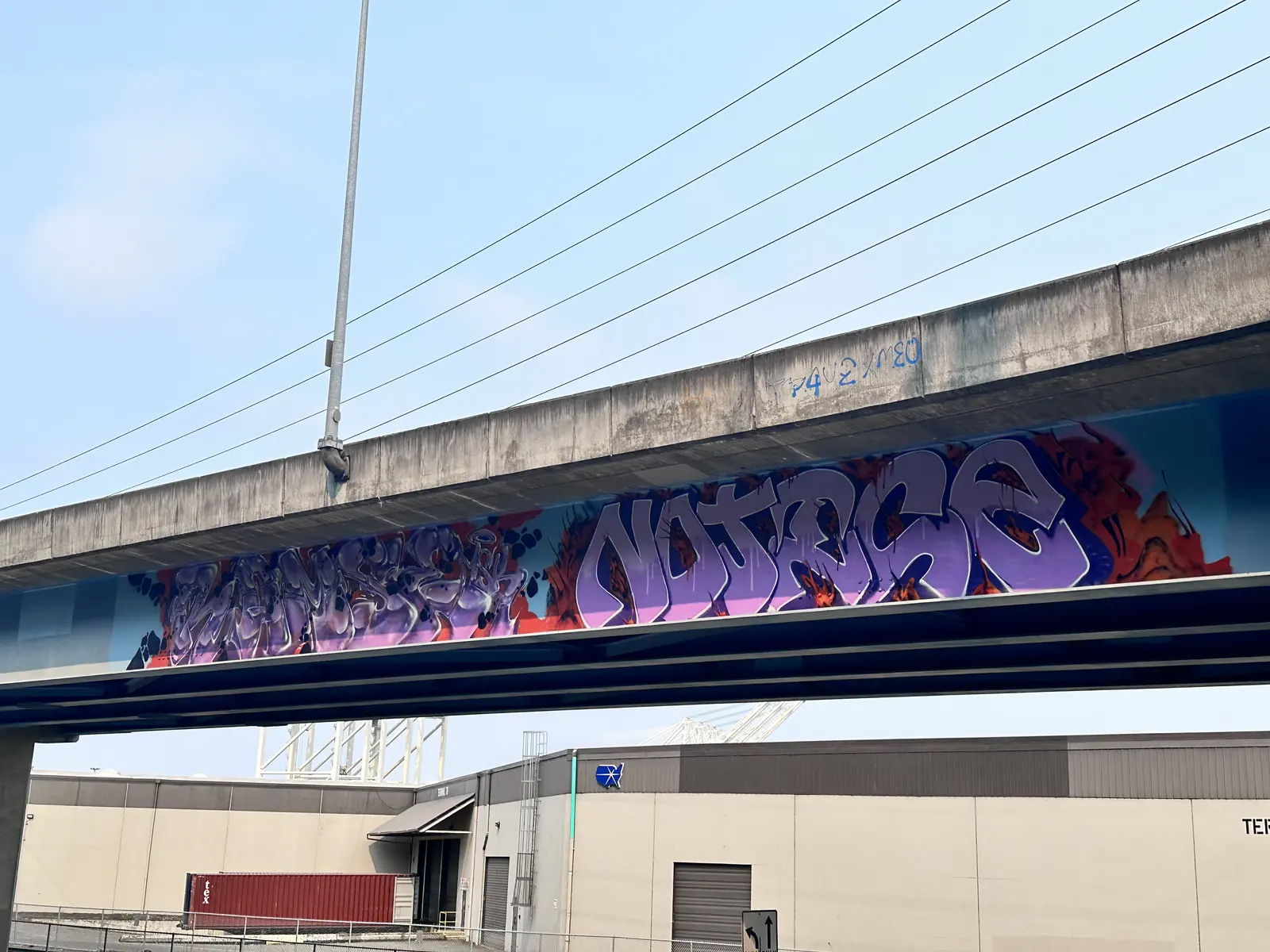 Graffiti painted along an elevated concrete structure