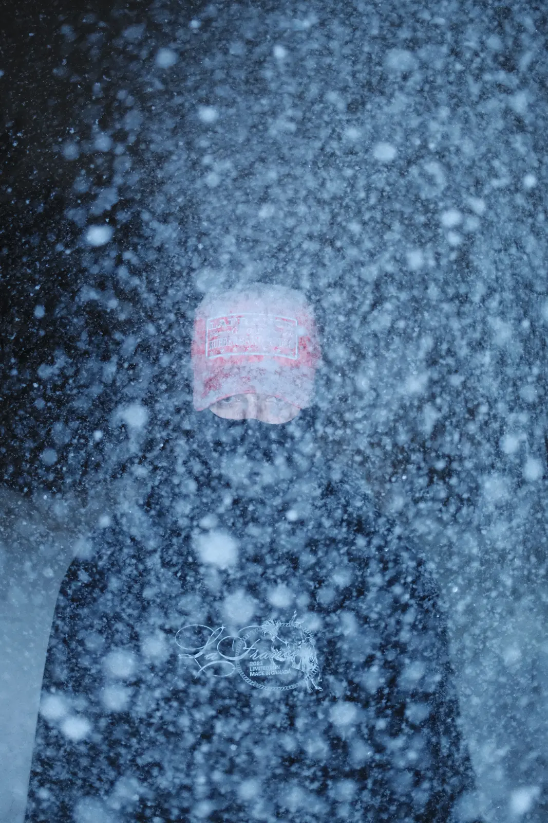 Red shape beneath a textured layer of snow