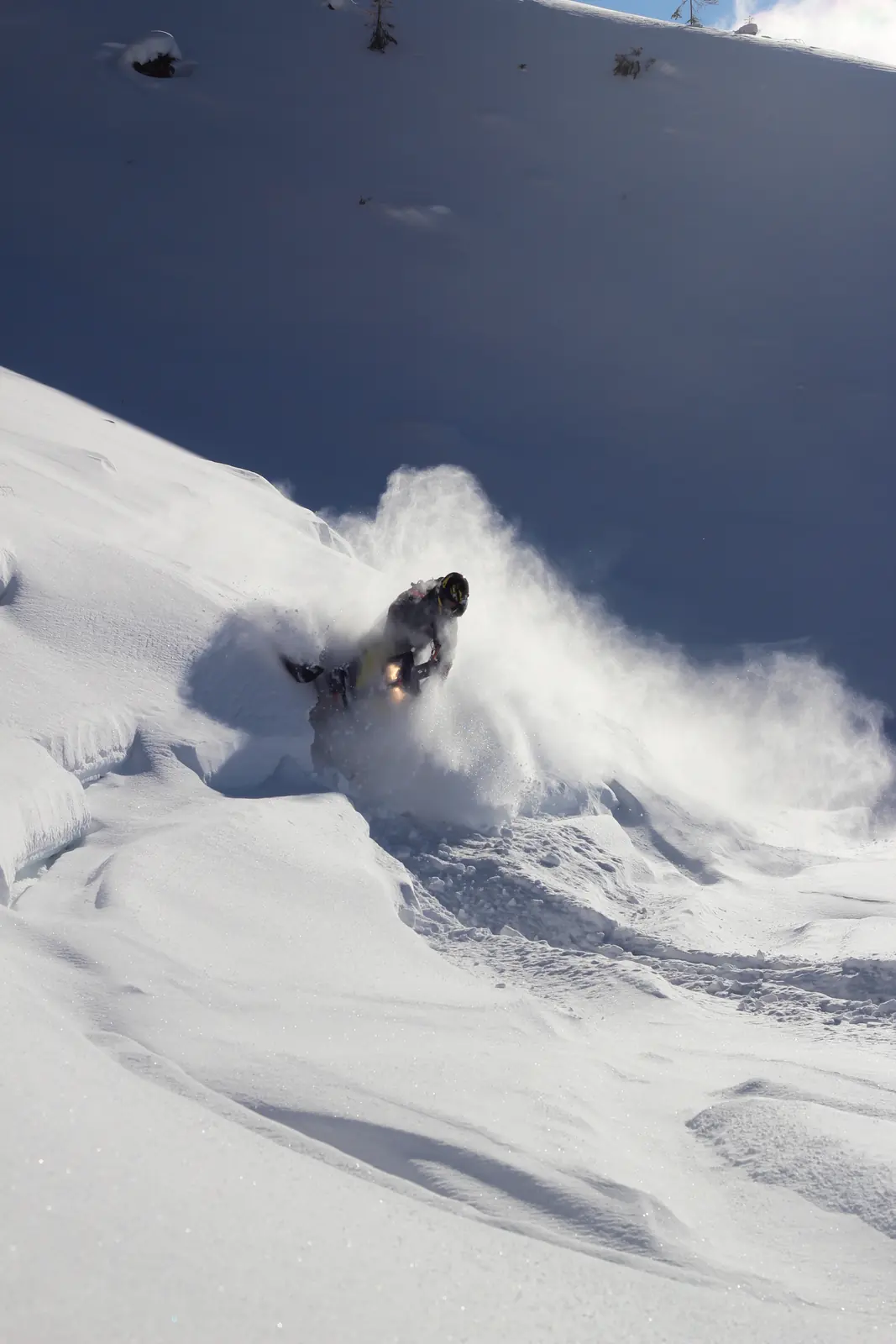 Skier carving through deep powder