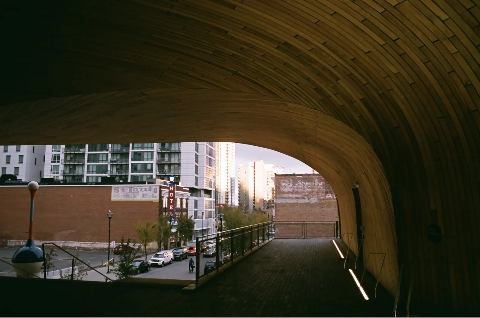 Person standing beneath a concrete overpass