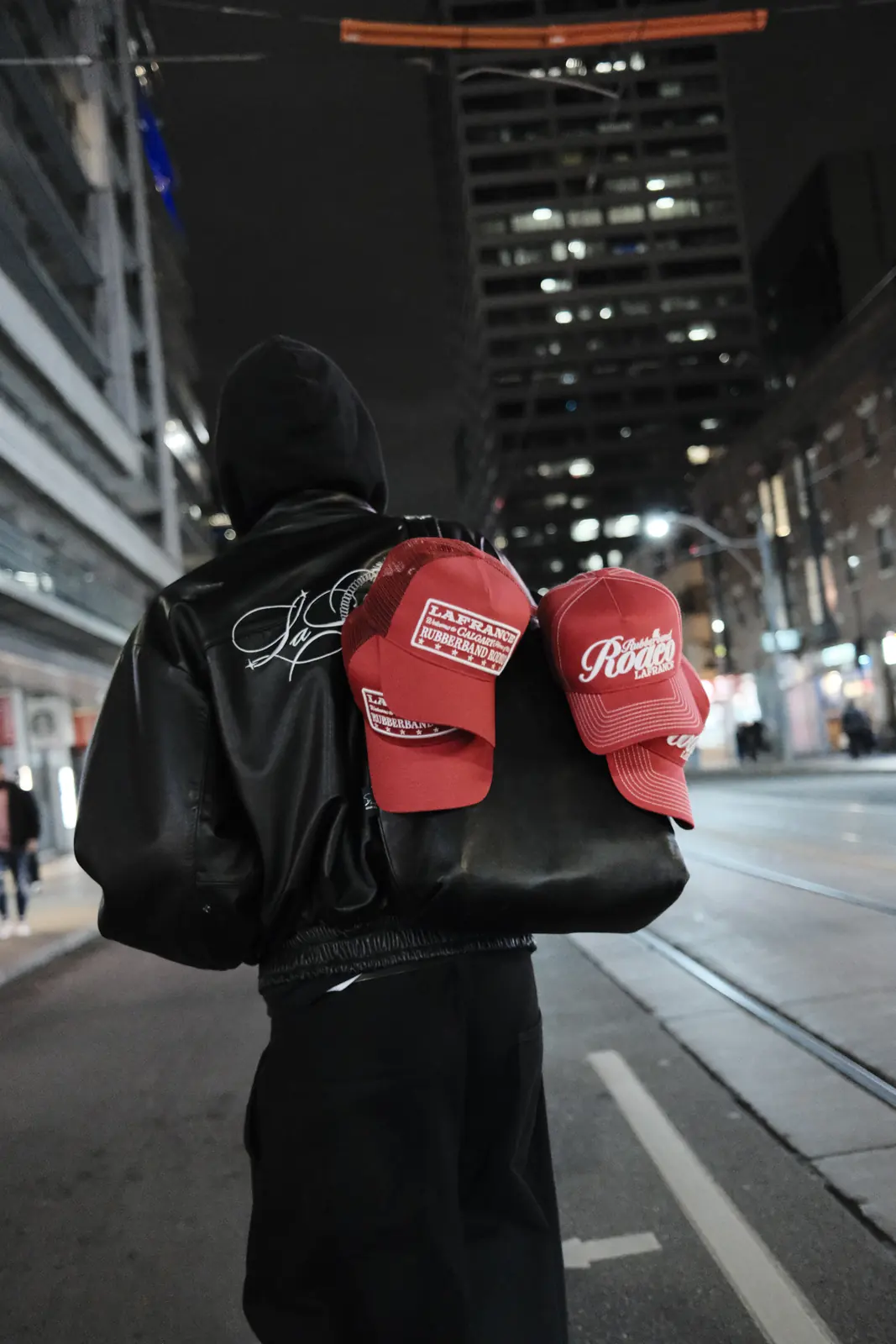 Two people wearing matching jackets and red caps