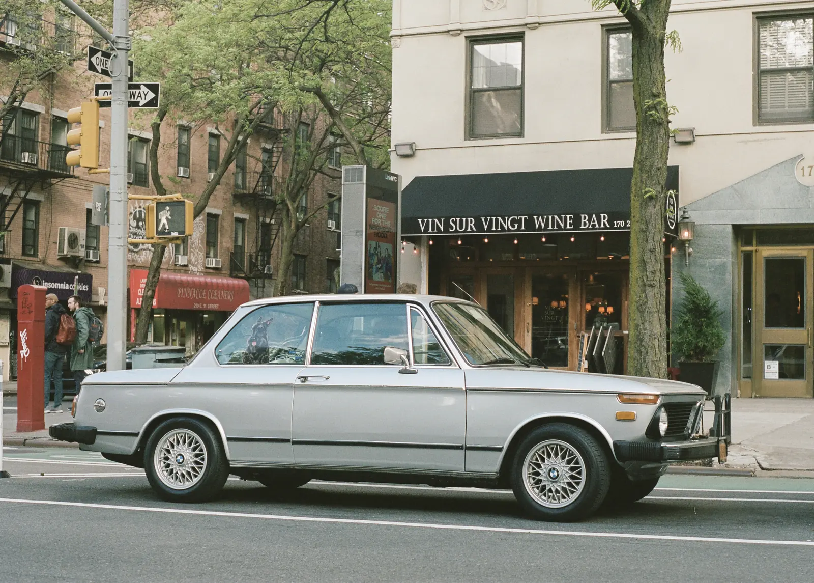 Vintage white car parked on a city street